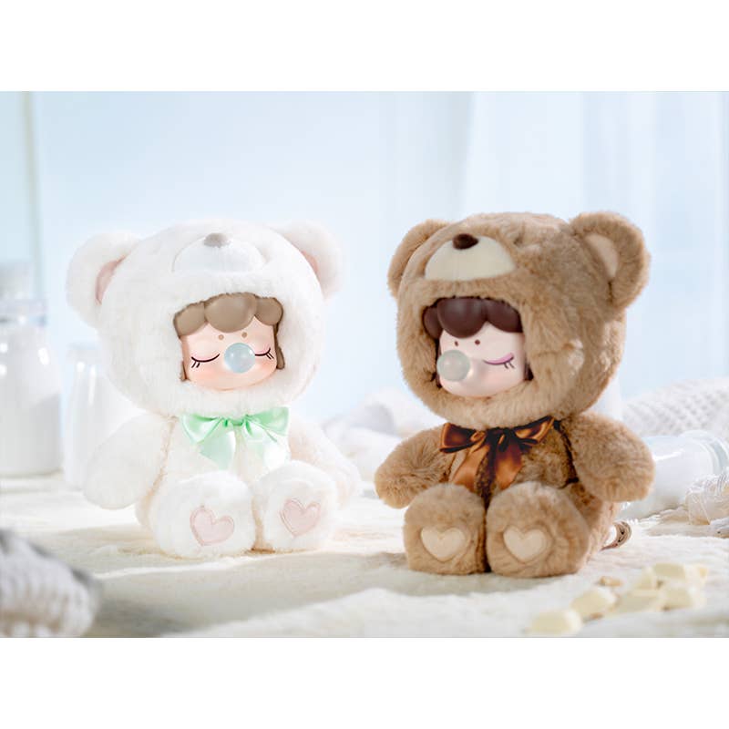 Two plush toys, one white with a face and the other brown bear-like with a face, on a light background.