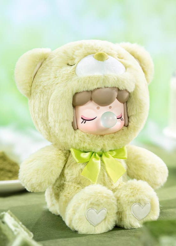 Green teddy bear with a bow on a green background